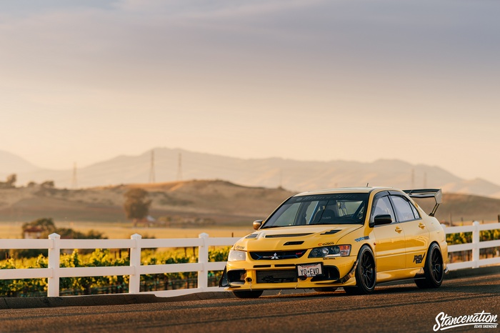 Yellow Mitsubishi Lancer Evolution VIII on a road