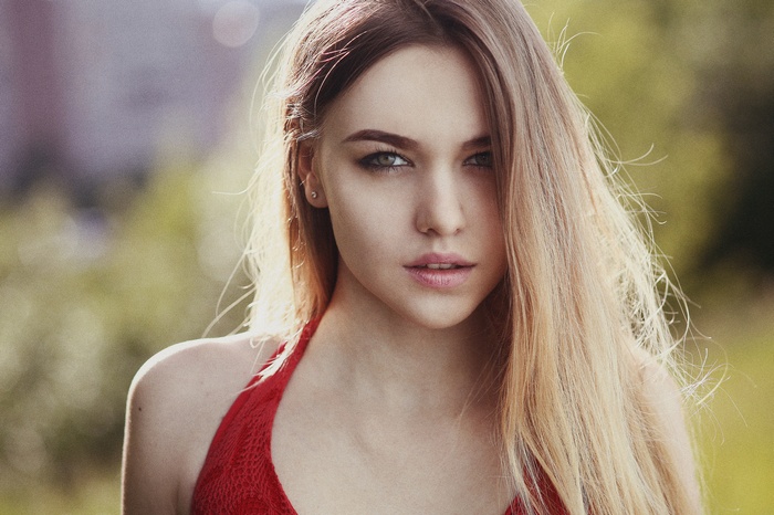 Portrait of a blonde woman with a red top