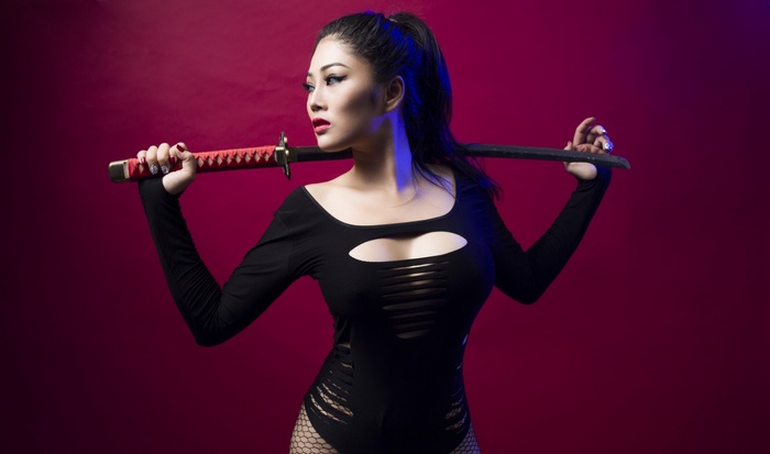 Asian woman holding a katana