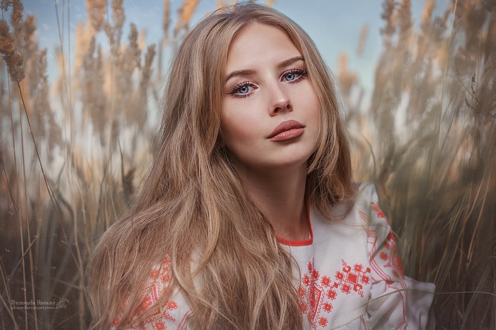 Woman with blonde hair in a field of tall grass