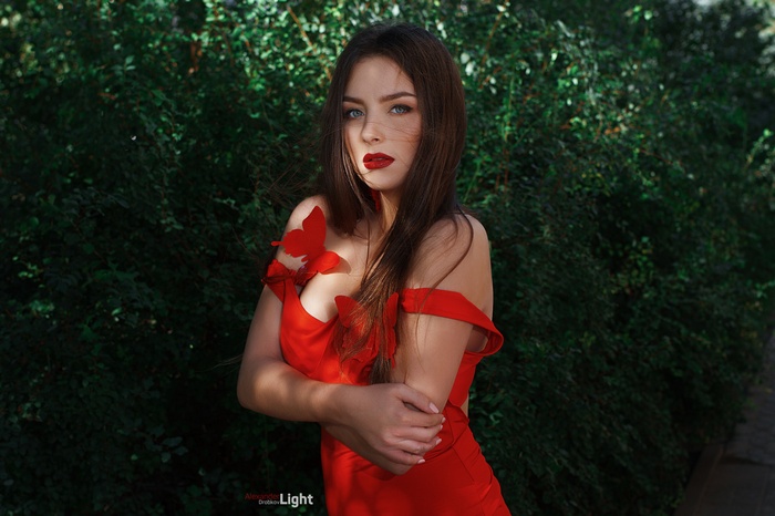 Woman in red dress with red butterflies