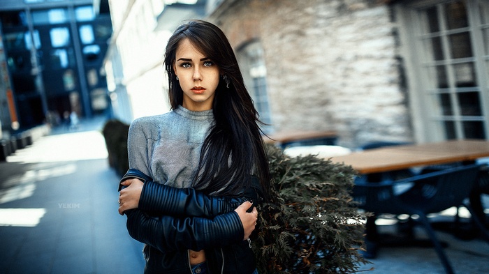 Woman with long black hair wearing a leather jacket