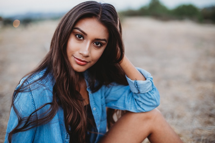Woman in denim shirt outdoors