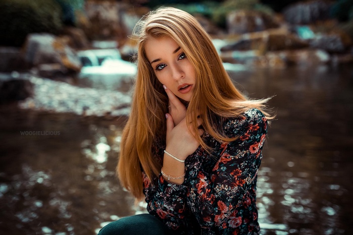 Woman with blonde hair by a river