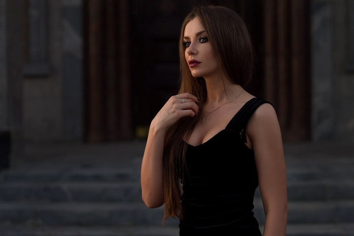 Woman in black dress looking away