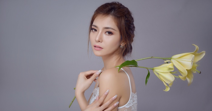 Asian woman with yellow lilies portrait