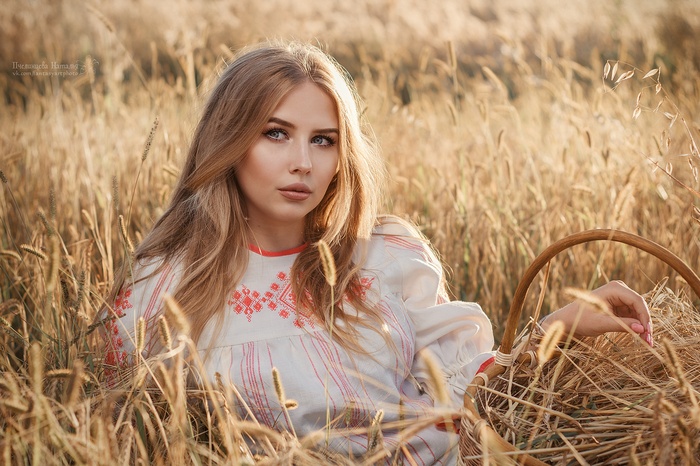 Woman in traditional clothing in a wheat field
