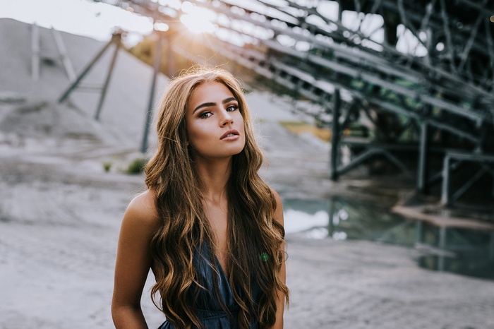 Woman with long blonde hair in a blue dress