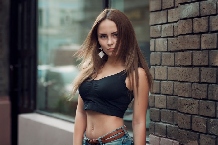 Woman in black crop top and jeans outdoors