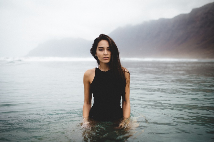 Woman in black swimsuit in the ocean