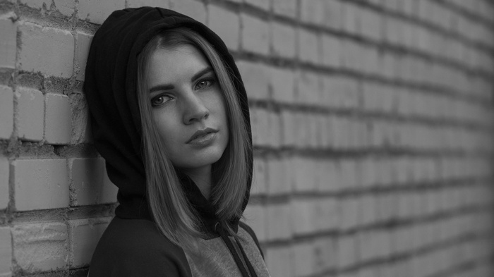 Monochrome portrait of a young woman in a hood