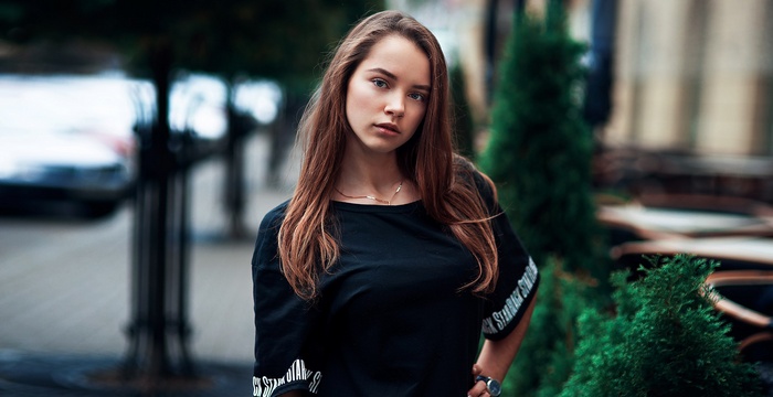 Young woman with long brown hair outdoors