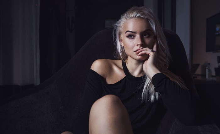 Woman with blonde hair wearing a black shirt