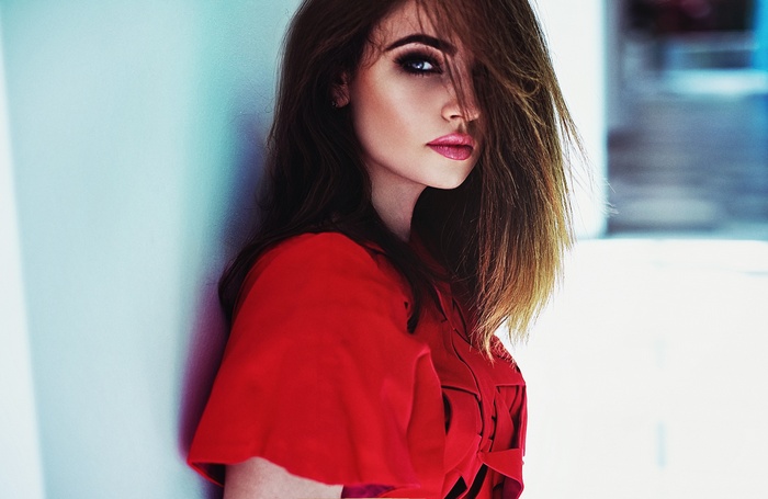 Woman in red dress with hair covering face