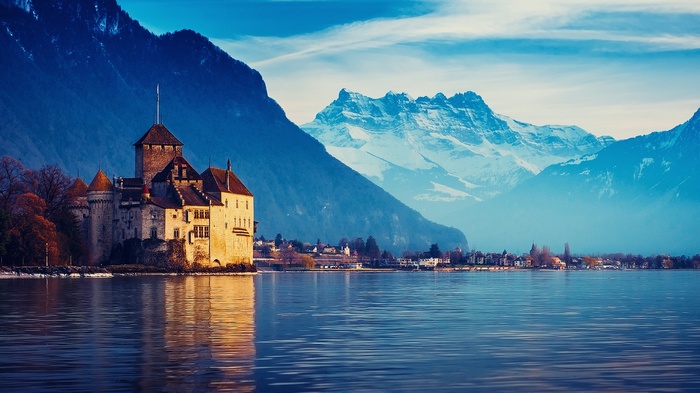 Chillon Castle on Lake Geneva with Alps Mountains
