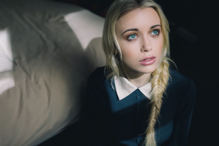 Woman with blonde plait and blue eyes