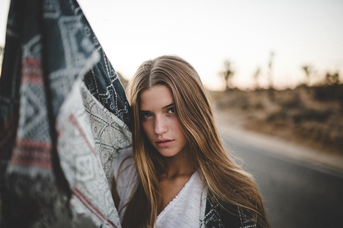 Woman with patterned scarf in desert landscape