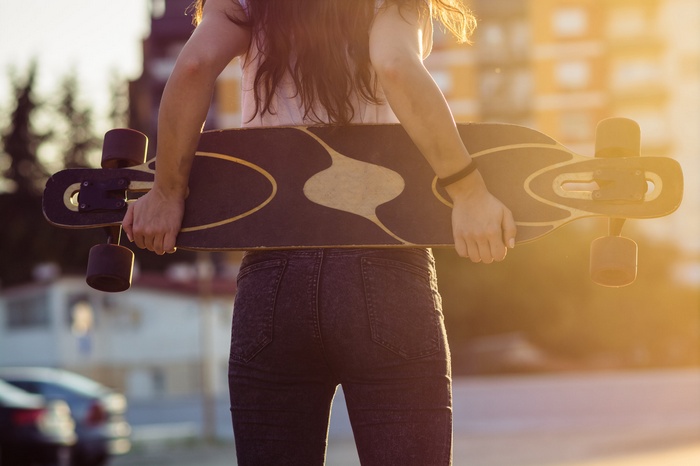 Woman holding a longboard