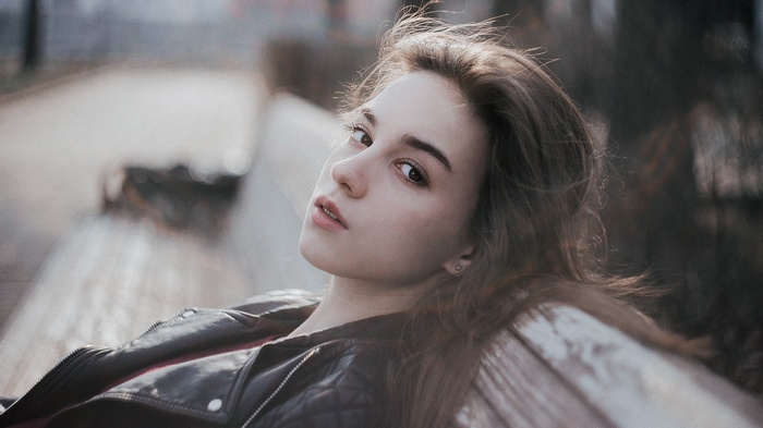 Lia Meyer sitting on a bench wearing a leather jacket