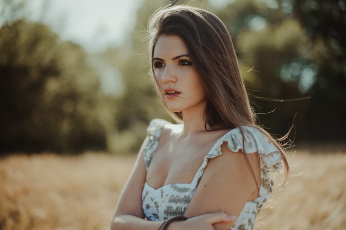Woman with long brown hair in a field
