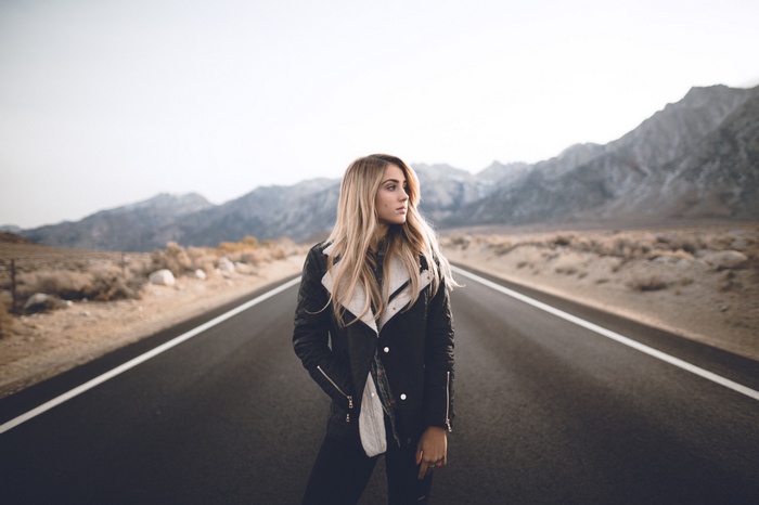 Charly Jordan on a desert road with mountains