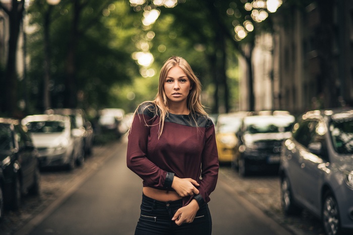 Woman in red shirt and black pants on a street