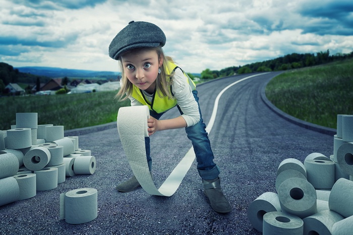 Child with toilet paper on a road