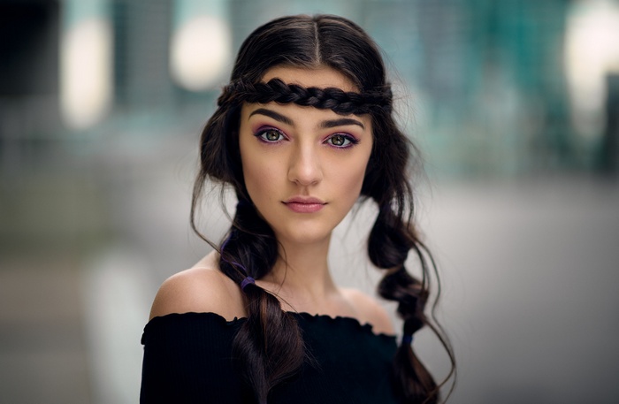 Woman with braided hair and purple eyeshadow