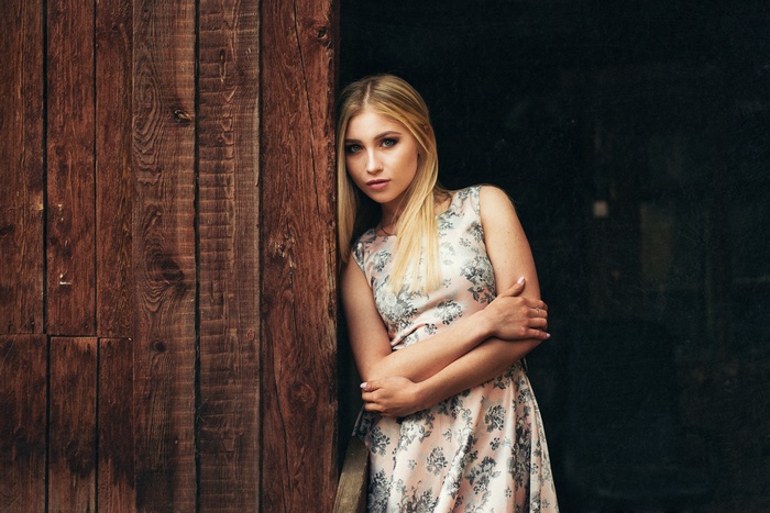 Blonde woman with blue eyes in a floral dress
