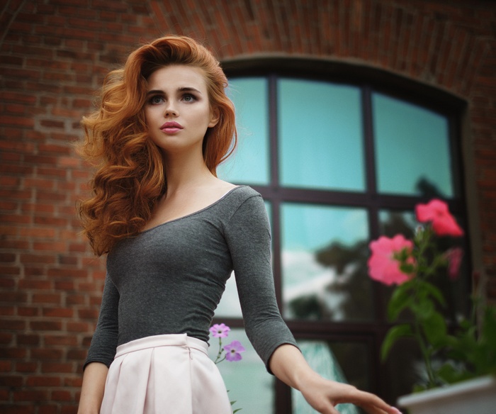 Redhead woman in grey top and skirt