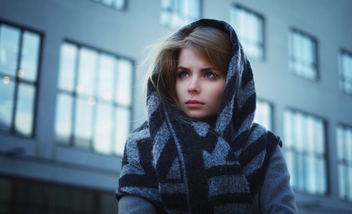 Woman with scarf and hood looking into the distance