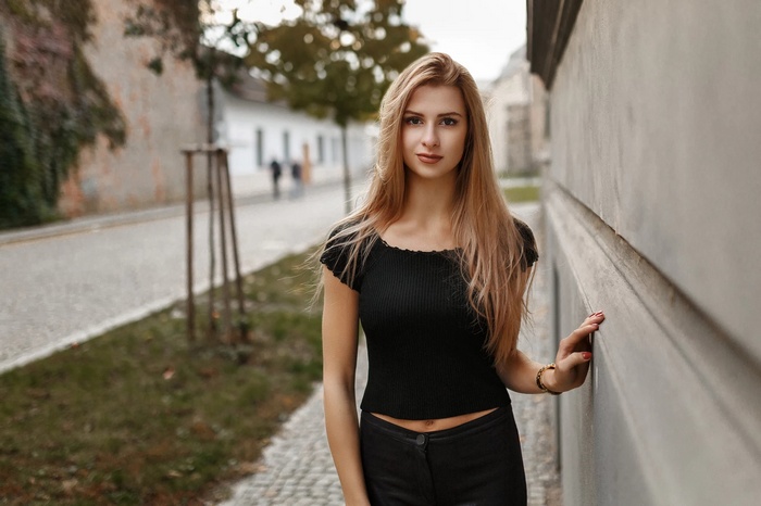 Woman with blonde hair wearing black top