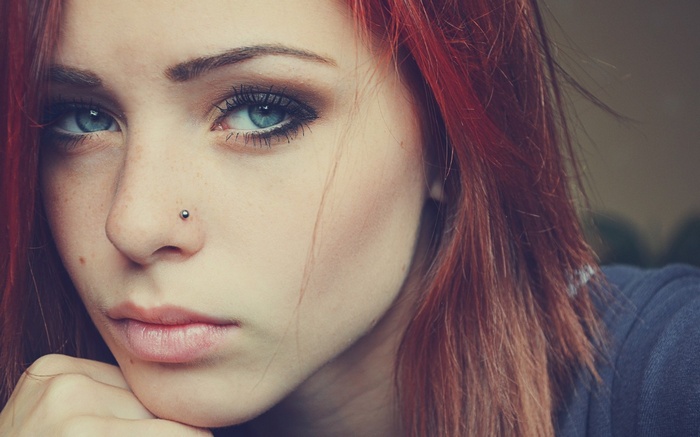 Woman with red hair and nose piercing