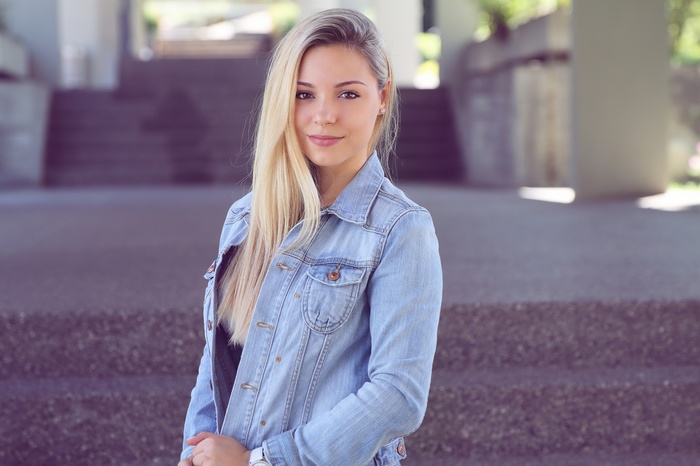 Woman in denim jacket looking at viewer