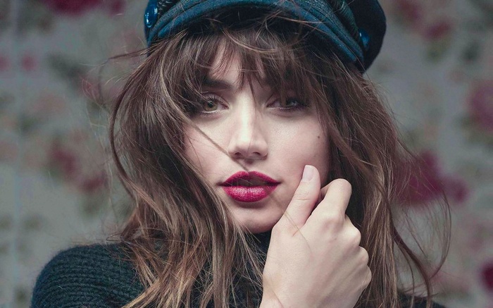 Ana de Armas wearing a blue hat and dark sweater