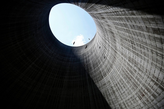 Birds flying inside a cooling tower