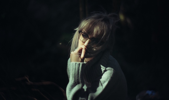 Woman with glasses in a grey sweater