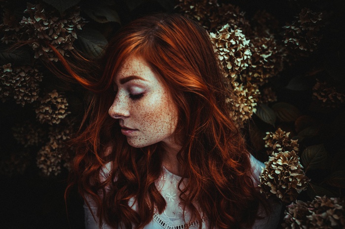 Redhead woman with freckles in profile