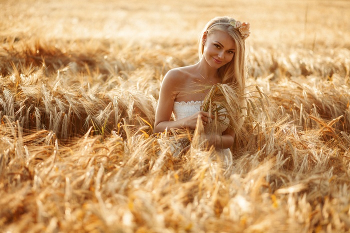 Woman in white dress in a wheat field