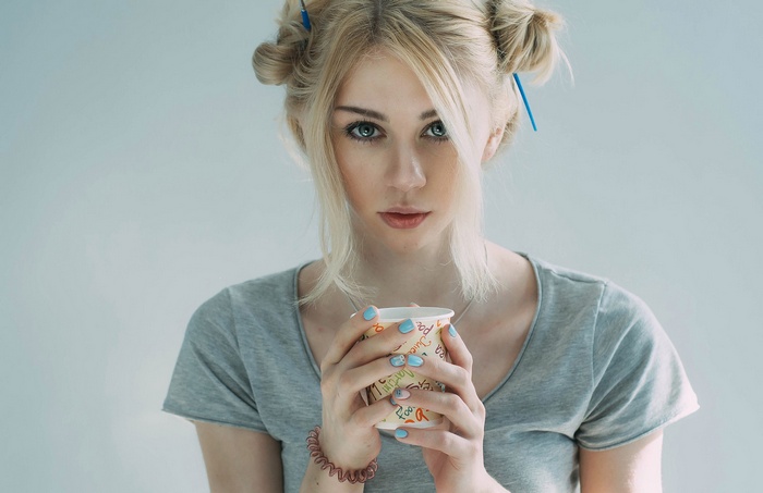 Woman with blonde hair holding a cup