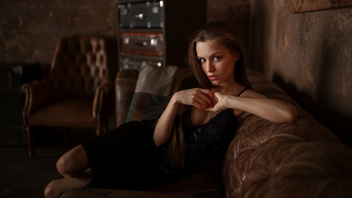 Fenix Raya in black dress on a couch