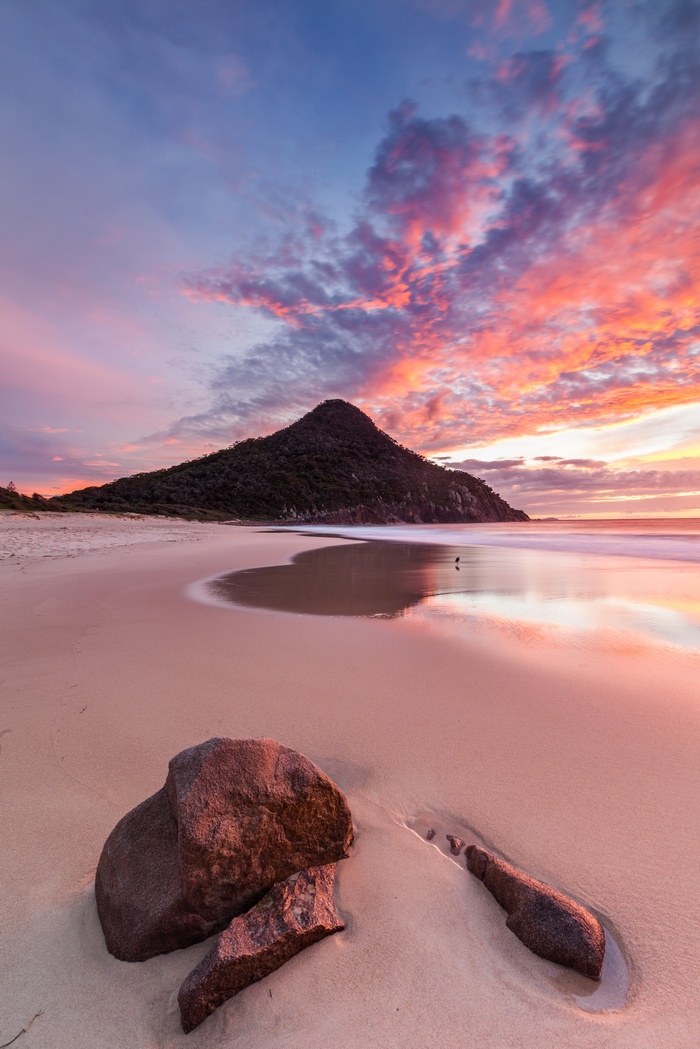 Beach with mountain and colorful sunset sky