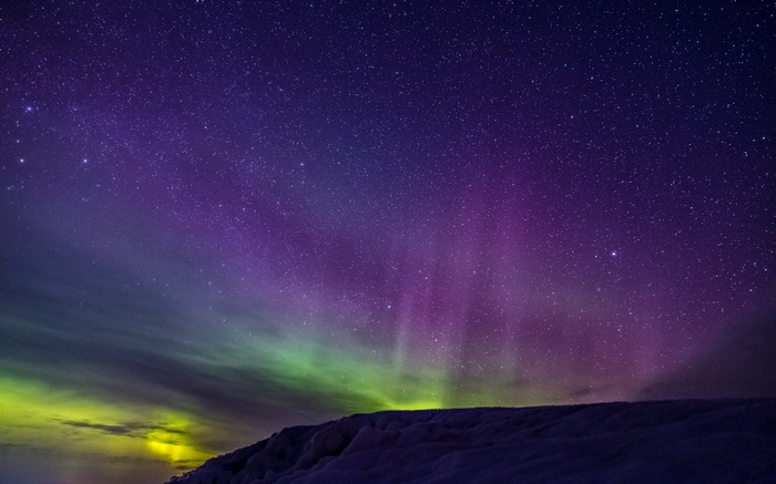Aurora Borealis over a snowy landscape