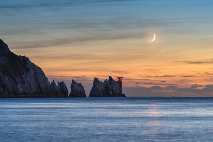 The Needles Lighthouse and Crescent Moon at Sunset