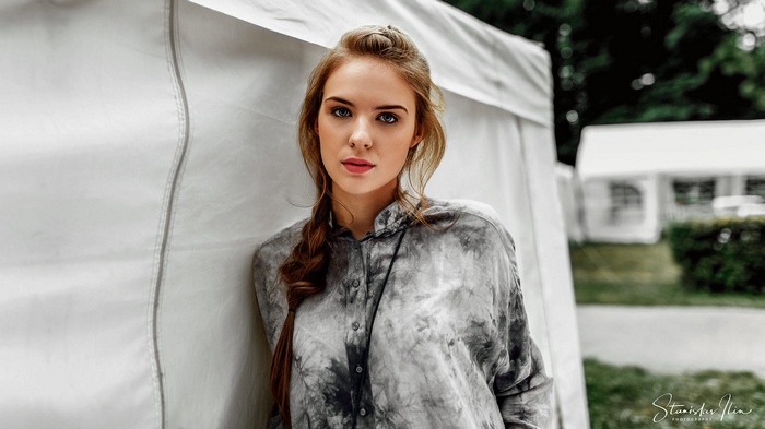Woman with braids and blue eyes outdoors
