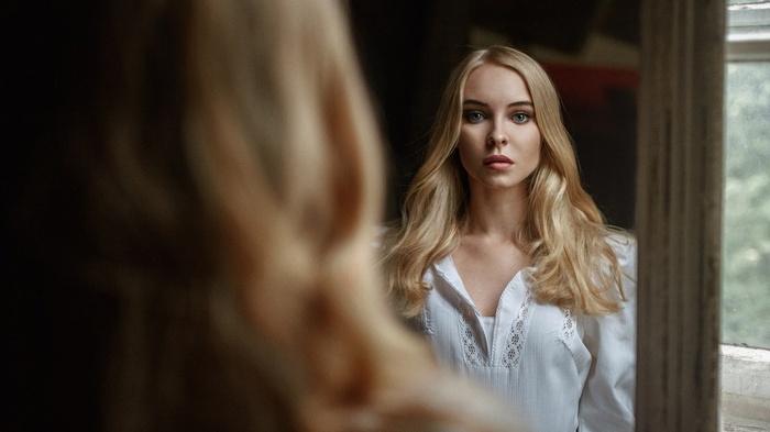 Viktoria Pichkurova in white shirt looking in mirror