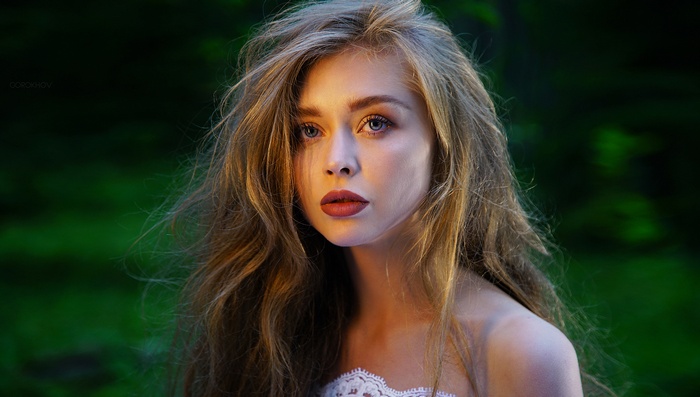 Portrait of a woman with long hair and red lipstick