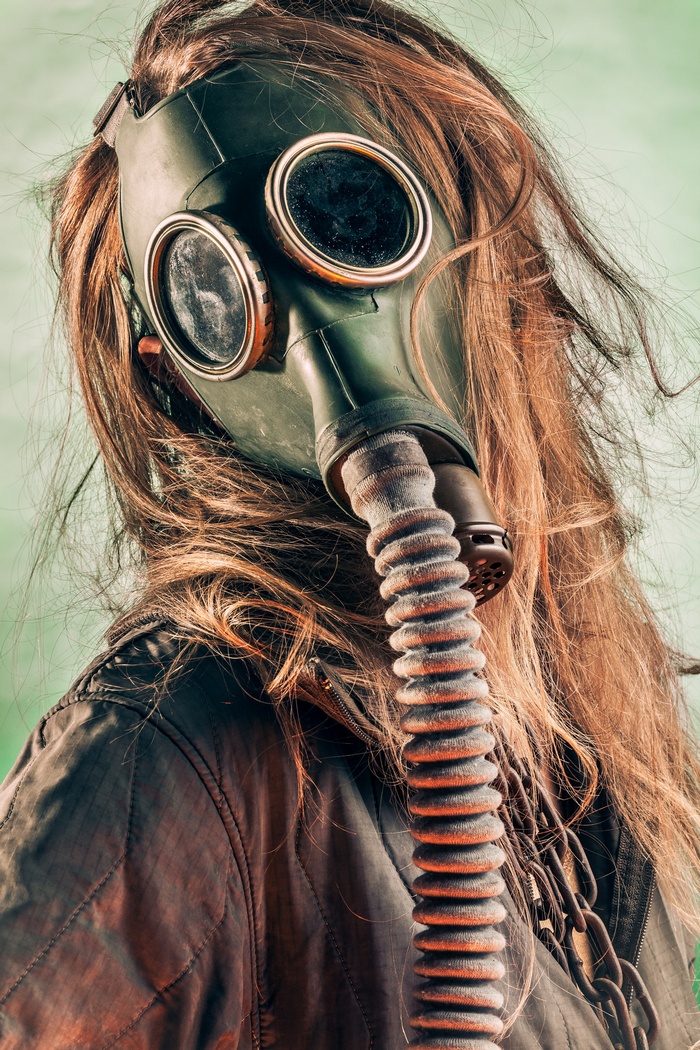 Woman wearing a gas mask and chains