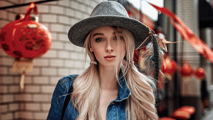 Woman with blonde pigtails wearing a hat