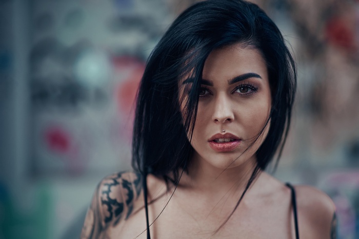 Woman with black hair and lip piercing